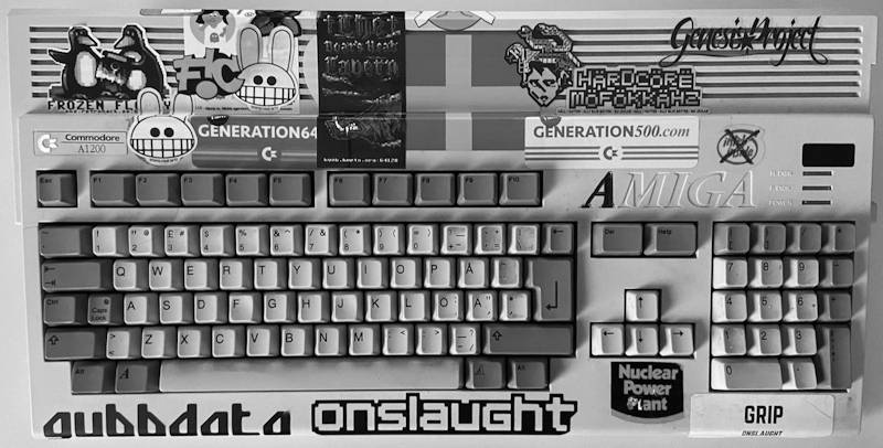 An Amiga 1200 thickly adorned with various computer- and demo scene-related stickers